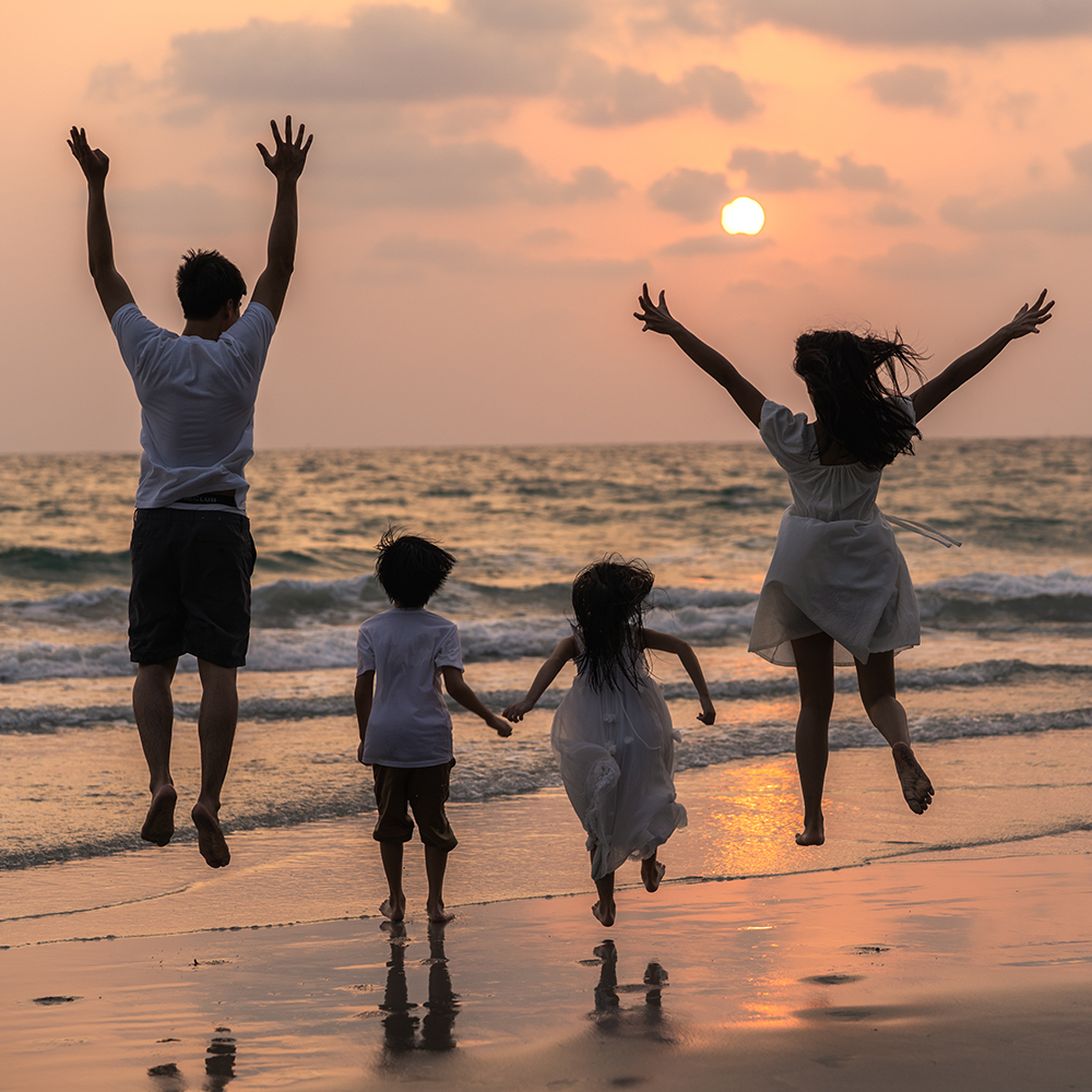 Family by sunset enjoying